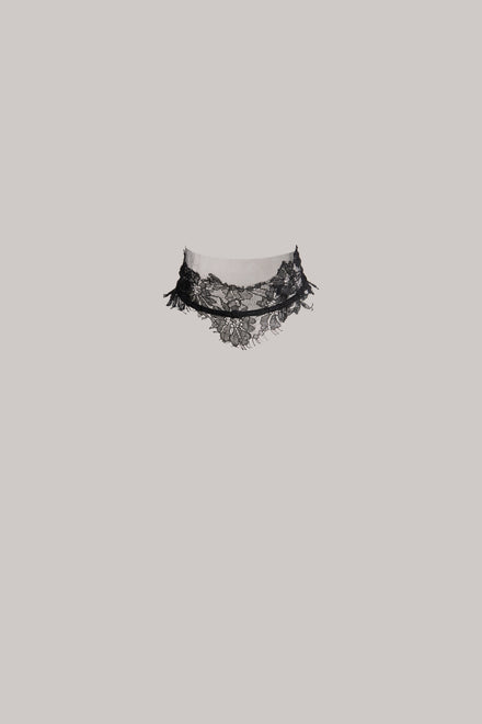 Black lace choker on a light gray background