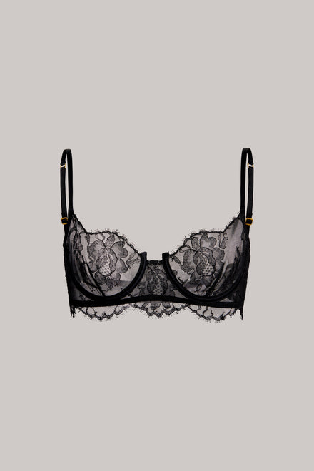Black lace underwire bra with floral lace cups and thin adjustable shoulder straps, shown flat against a solid light gray background.