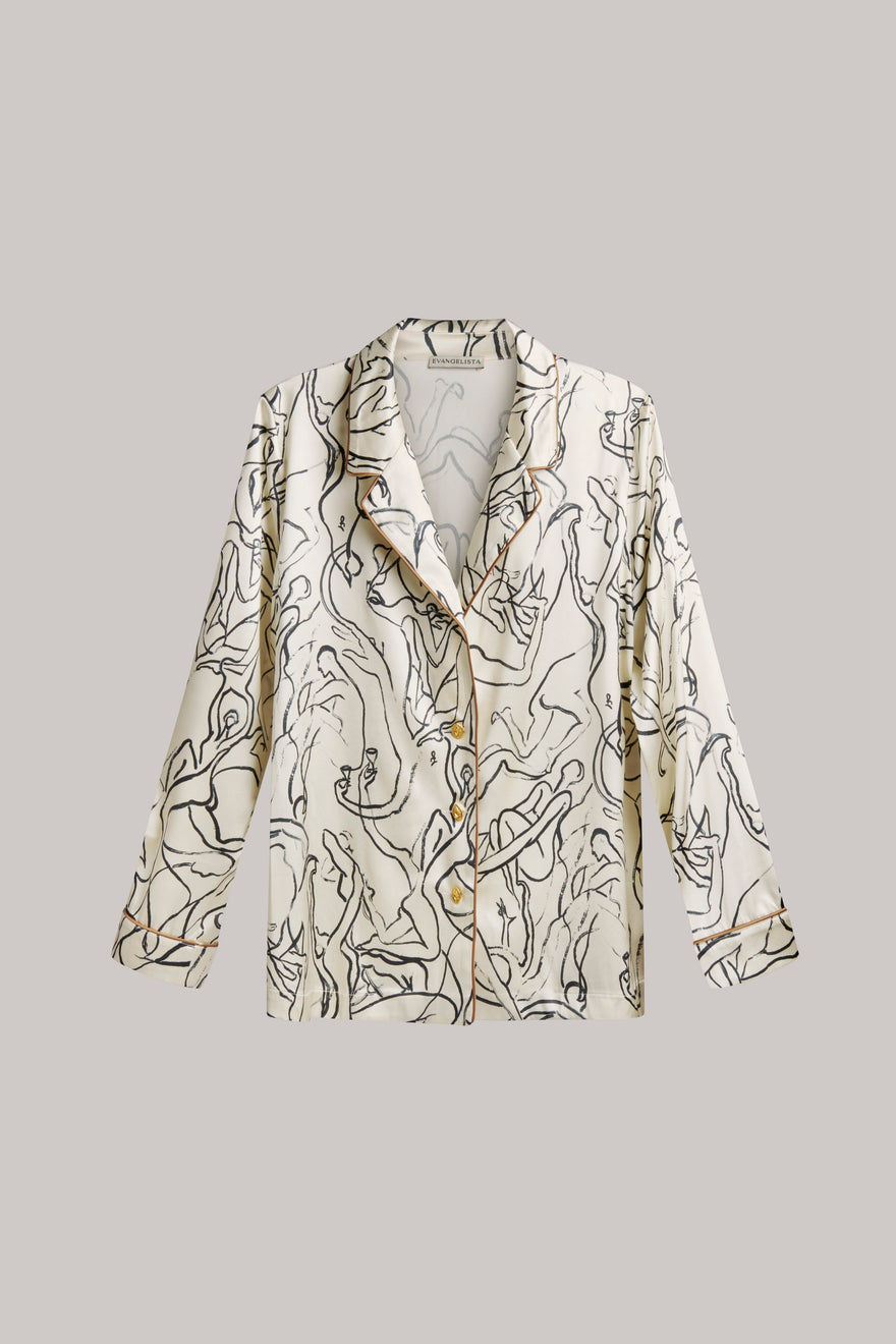 A long-sleeve button-front shirt jacket with a soft, flowing silhouette and an abstract black line art print on a warm cream background, shown against a solid light gray background.