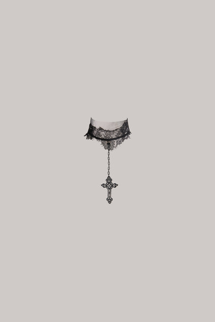 A black lace neck piece with a dangling ornate cross charm, shown against a solid light gray background. Sold separately.