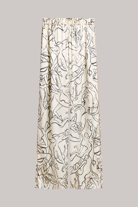 Wide-leg pants with an abstract black line art print on a warm cream background, shown against a solid light gray background.