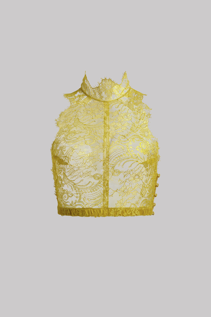 A yellow lace bustier top with a high mock neck, sheer floral embroidery, and a fringed hem, shown against a solid gray background.