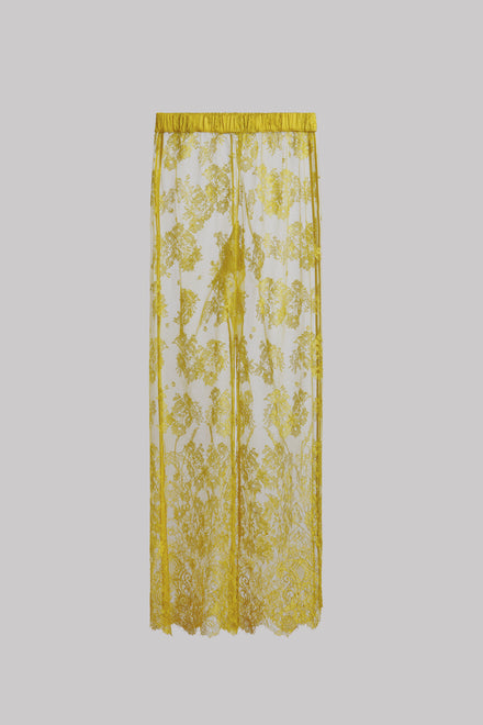 A sheer yellow lace pant with an intricate yellow floral pattern and a matching yellow top border, shown against a solid gray background.