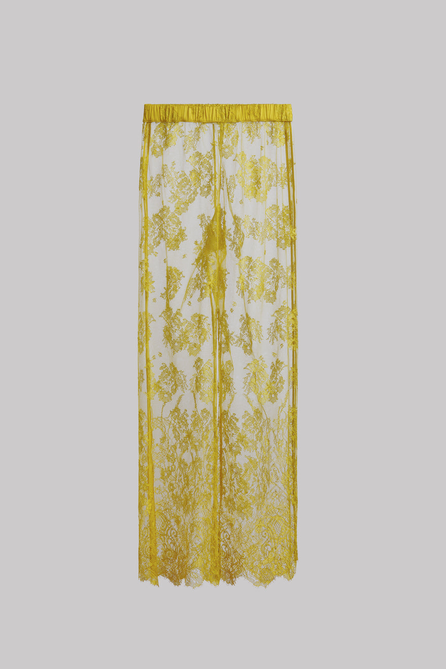 A sheer yellow lace pant with an intricate yellow floral pattern and a matching yellow top border, shown against a solid gray background.