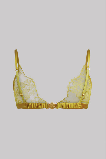 A yellow lace and satin triangle bralette with a ruffled underband and a central decorative gold-tone clasp, shown against a solid gray background.