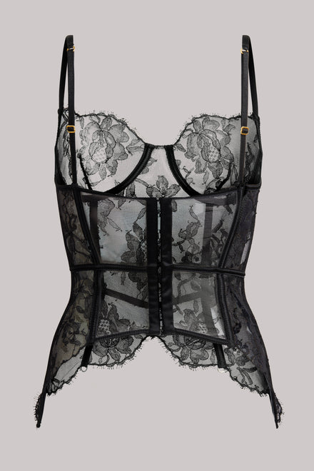 Black lace and mesh corset-style lingerie top with floral lace cups, sheer panels, thin shoulder straps, and a center front closure, shown against a plain light gray background.
