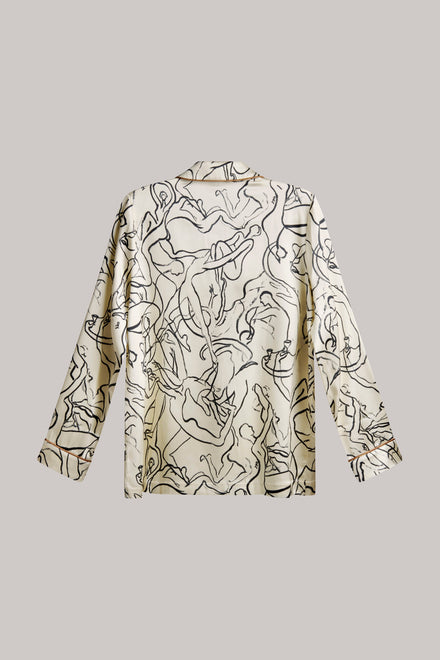 A long-sleeve collared shirt with an abstract black line art print on a warm cream background, displayed flat against a solid gray background.