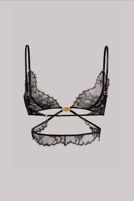 Black lace underwire bra with gold-tone hardware and a matching black lace waist strap, displayed against a solid light gray background.