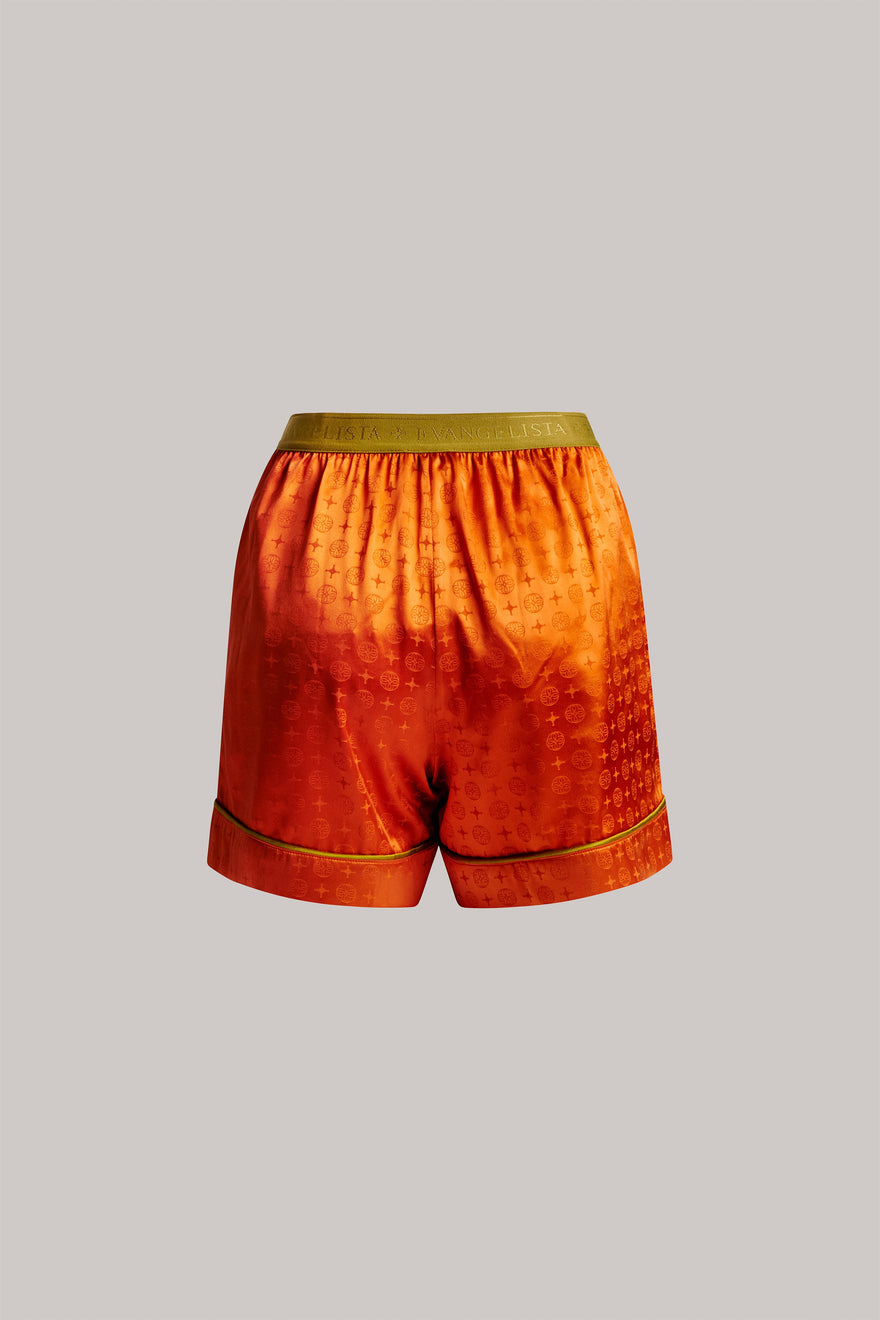 Orange shorts with a pattern on a gray background