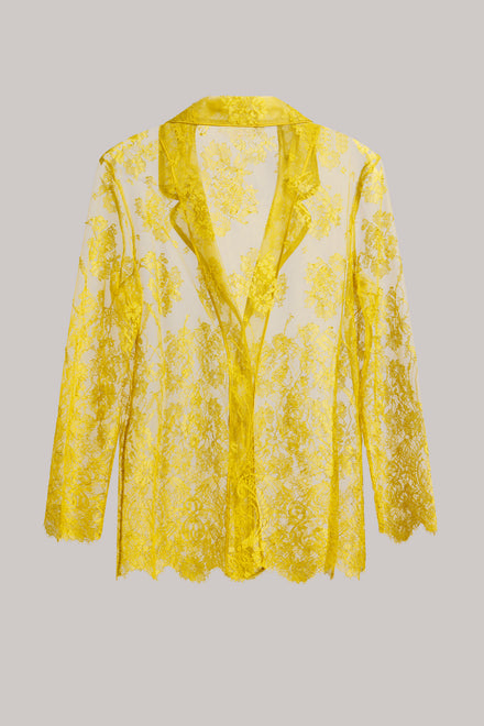 A yellow and white floral lace long-sleeve blazer with a scalloped hem and collar, displayed against a solid gray background.