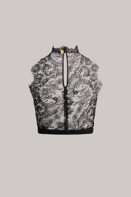 Black lace crop top with a high mock neck, front keyhole cutout, and a small gold button detail at the collar, shown flat on a light gray background.