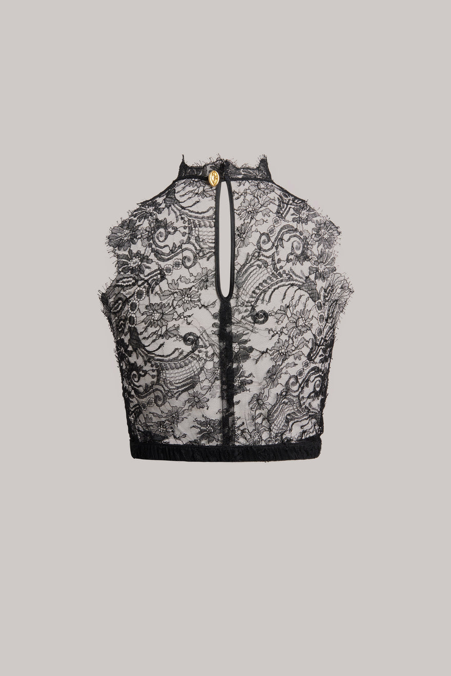 Black lace crop top with a high mock neck, front keyhole cutout, and a small gold button detail at the collar, shown flat on a light gray background.